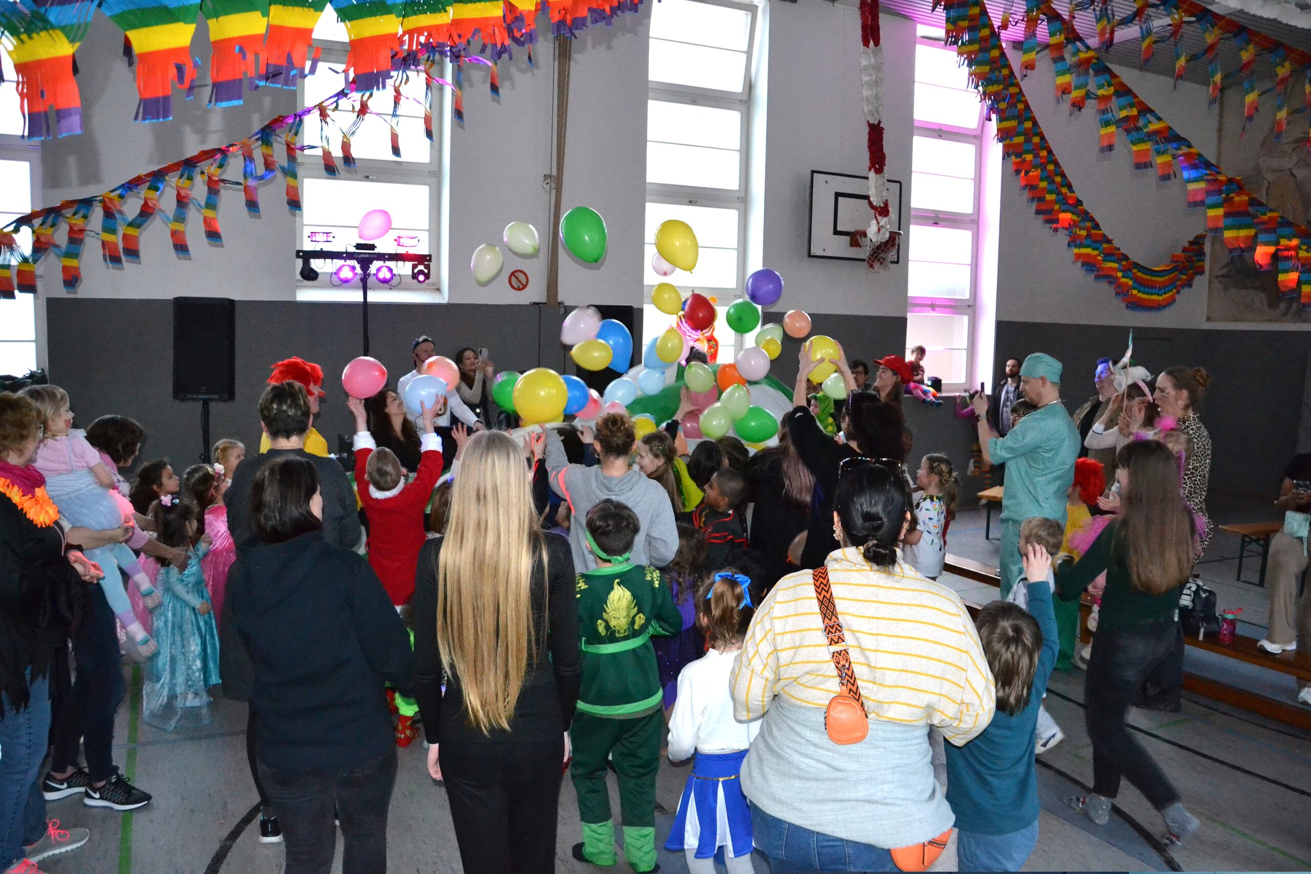 tanzende Kinder vor einem DJ Pult mit Luftballons